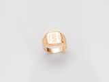 a close up of a gold ring with a square signet on it