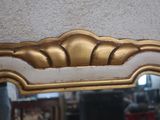 a mirror that has a gold frame on it
