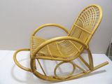 a yellow rocking chair that is sitting on a white surface