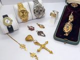 many different types of watches and jewelry on the table