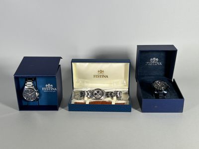 three watches in a blue box and a watch in a blue box