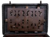 a wooden box with a metal design inside of it