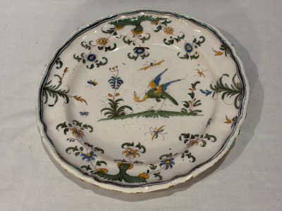a plate with a bird on it on a table