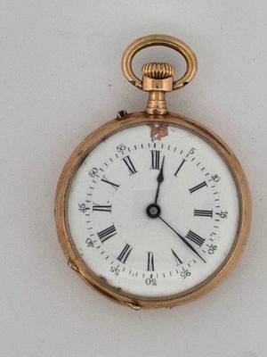 a gold pocket watch with roman numerals on the face