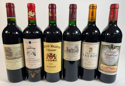 six bottles of wine are lined up in a row on a white surface