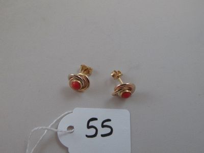 two pairs of red and gold earrings with a price tag