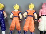dragon ball action figures lined up in a row on a gray surface
