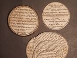 four wooden coasters sitting on top of a table with writing on them