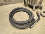 a vacuum and a hose on the floor next to a hose