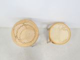 two wicker chairs and a round table in a white room