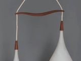 two white and brown hanging lamps on a gray wall