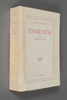 an old book on a gray surface with a red border