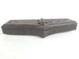 an old wooden box with a handle sitting on a white surface