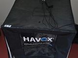 a black box sitting on the floor next to a wall
