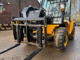 a forklift that is parked in the dirt