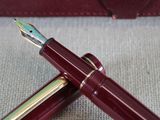 two fountain pens sitting next to each other on top of a table