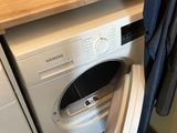 a washer and a dryer in a small room
