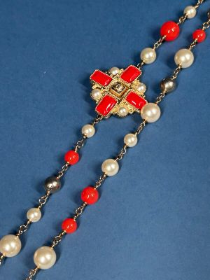 a close up of a rosary with red and white beads