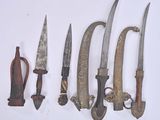 several different types of knives are lined up on a white surface