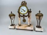 a clock that is sitting on top of a marble stand
