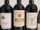 several bottles of wine are lined up in a row on a table