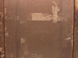 an old wooden door with a rusted metal frame