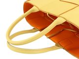 yellow leather handbag with strap on white background on white background