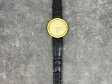 a close up of a wrist watch on a gray surface