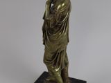 bronze statue of a woman holding a child on a marble base