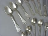 a lot of silver spoons and spoon spoons on a table