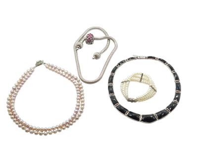 three pieces of jewelry including a necklace, bracelet, and ring