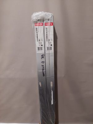 pair of nintendo wii game consoles in plastic wrap on a table