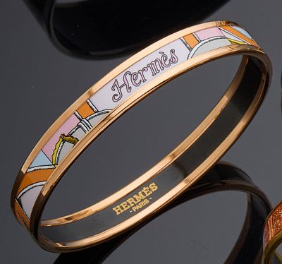three different colored bang bracelets on top of a black surface
