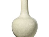 a white and gold vase on a stand on a white background
