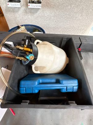 a picture of a blue box with a gas can and a hose attached to it