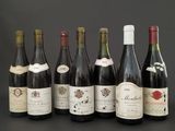 several bottles of wine are lined up on a table