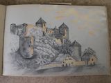 a drawing of a castle in a book on the floor