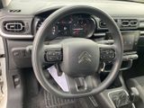 the interior of a car with a steering wheel and dashboard controls