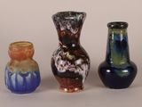 three vases sitting next to each other on a table