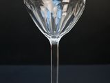 a wine glass sitting on a table with a black background