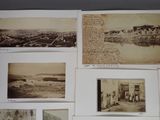 many old photos of people and buildings on the wall