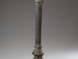 an old metal pole with a metal ball on top of it