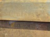 a close up of a piece of wood with writing on it