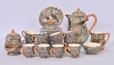 many cups and saucers that are sitting on a table