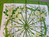 a green table cloth with white flowers on it