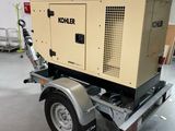 a trailer with a small generator on it in a garage