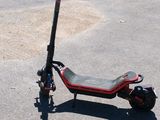 a scooter that is sitting in the parking lot