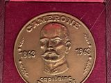 a close up of a gold medal in a red box