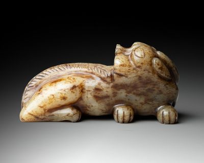 an image of a sculpture of a cat laying down on its back