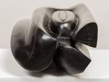 a black sculpture on a white surface with a white background